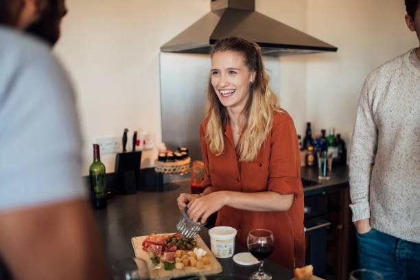 istock Friends Preparing Food at Home 874492814