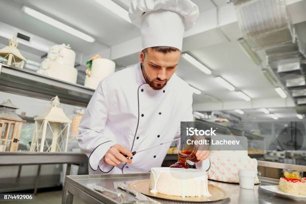 A Confectioner With A Cake In The Bakery Stock Photo - Download Image Now - Cake, Chef, Confectioner