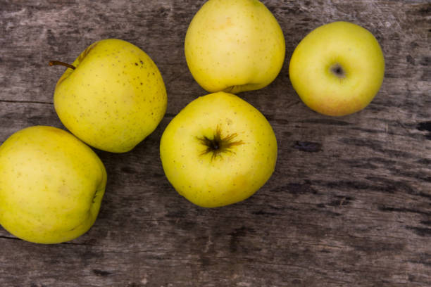 istock Ripe green apples on rustic wooden table 874498064