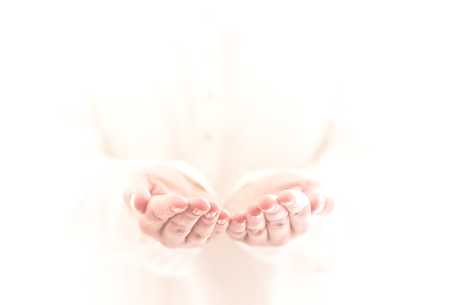 Horizontal shot of the empty female hands outstretched, isolated, background blur