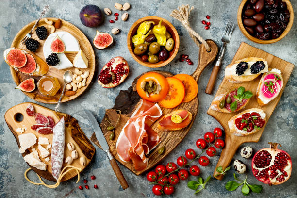 istock Appetizers table with italian antipasti snacks. Brushetta or authentic traditional spanish tapas set, cheese variety board over grey concrete background. Top view, flat lay 874502788
