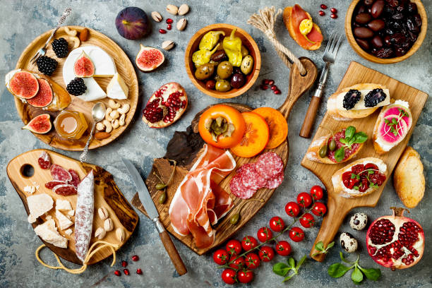 istock Appetizers table with italian antipasti snacks. Brushetta or authentic traditional spanish tapas set, cheese variety board over grey concrete background. Top view, flat lay 874502898