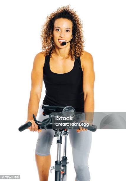 Woman On An Exercise Bike Stock Photo - Download Image Now - Fitness Instructor, White Background, 20-29 Years