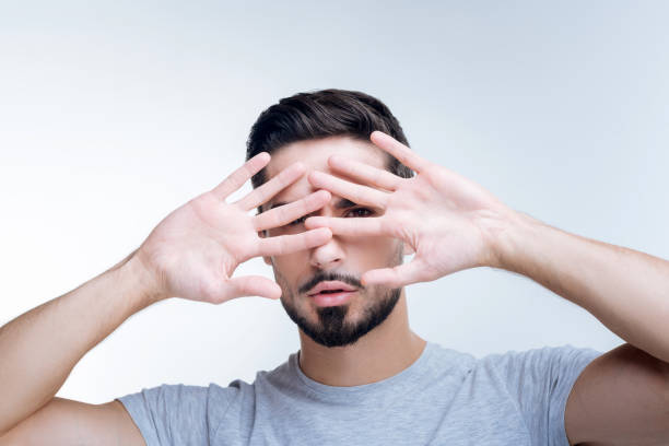 istock Shy young person hiding his face from unknown people 874540634
