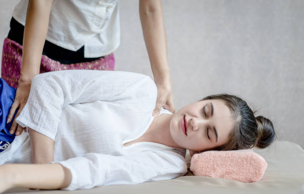 istock Woman relaxing with closed eye getting massage on spa bed 874540952
