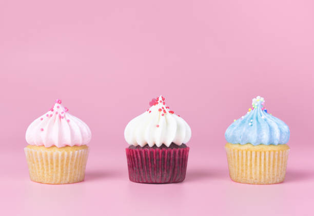 istock Three Colorful Cupcake on pink background with copy space 874541252