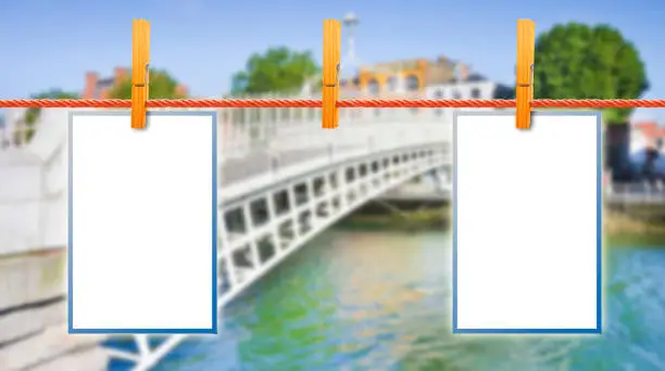 Photo of Blank photos hanging on clothesline with Half Penny Bridge on background (Dublin - Ireland)