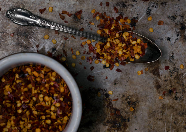 istock Red Pepper Flakes on an Old Metal Pan Background 874548298