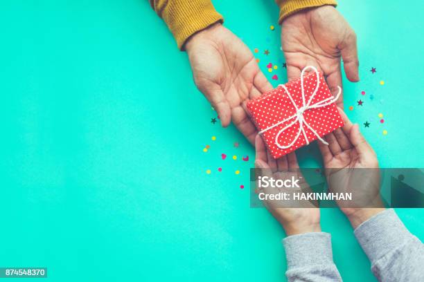 Male Gives A Gift To Female With Copy Space Stock Photo - Download Image Now - Gift, Giving, Receiving