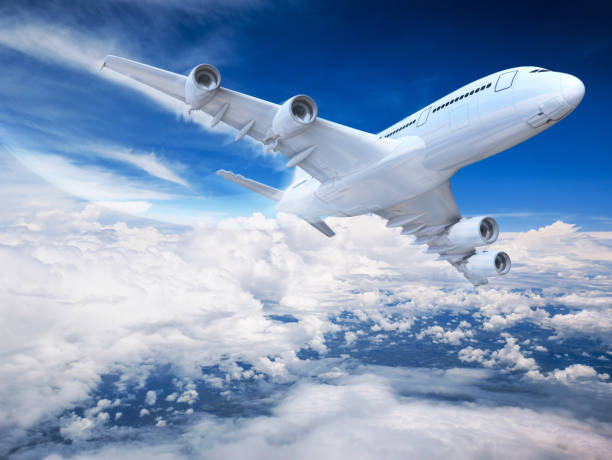 istock Commercial airplane flying above clouds 3D rendering 874563192