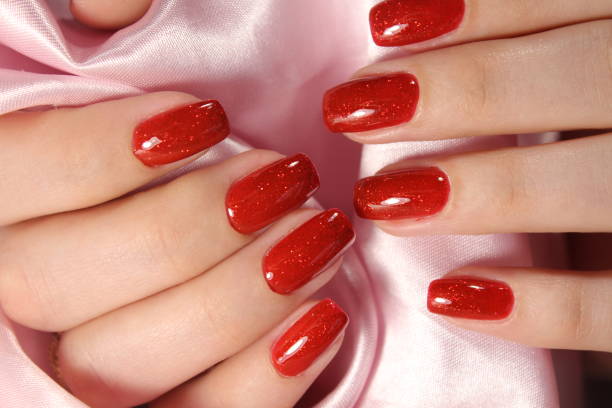 istock beautiful female hands with sexy red manicure. 874565970