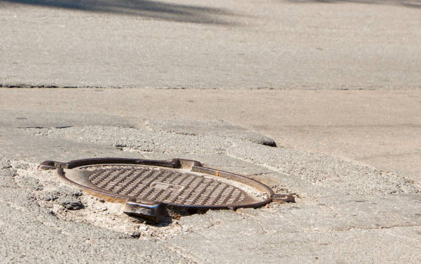 istock Waterfilled pothole on asphalted road 874566606