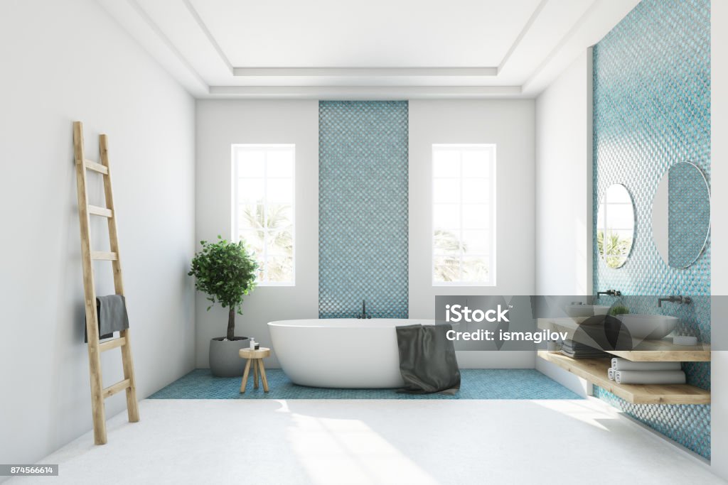 Blue and white bathroom, white tub White and blue bathroom interior with a round white tub, two narrow windows, a tree in a pot and a ladder in a corner. Side view. 3d rendering mock up Bathroom Stock Photo