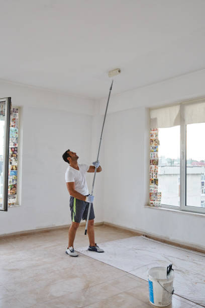 istock Indian worker painting walls 874569344