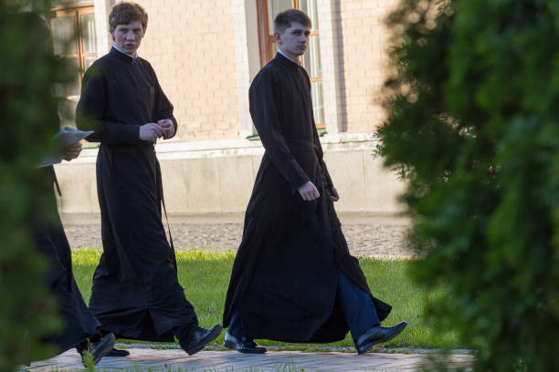 Young seminarians on the territory of St. Michael's Golden-Domed Monastery stock photo