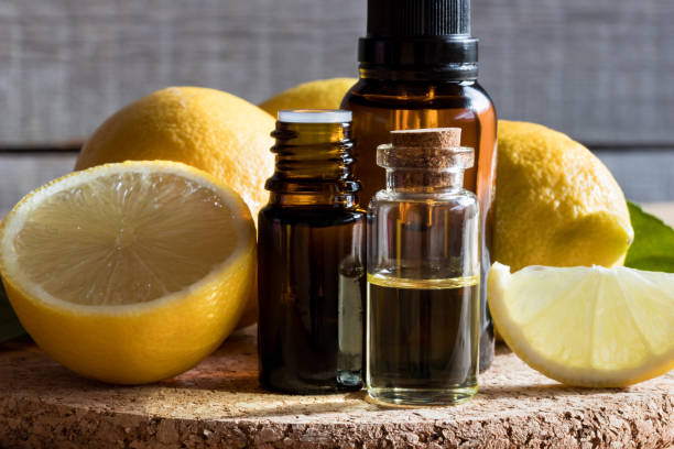 istock Bottles of lemon essential oil with lemons 874583812