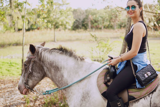 istock girl preparing to ride a horse 874587234