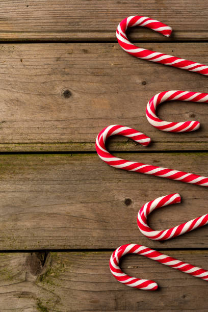 istock Candy cane on an old wooden table 874596386