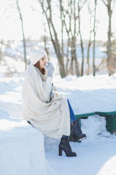 istock Girl drinking hot tea from a thermos 874599380