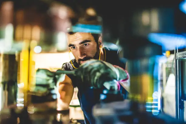 Photo of Worker Repair Cold Forging Machine