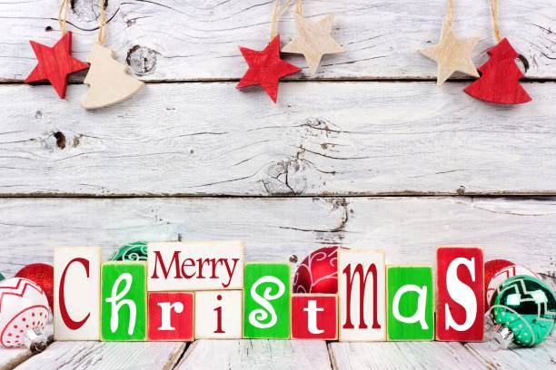 istock Merry Christmas wooden letters over rustic white wood 874606434