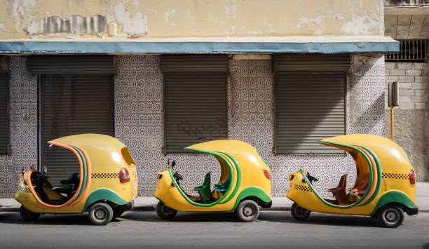 istock Small cuban coco taxis in line 874609094
