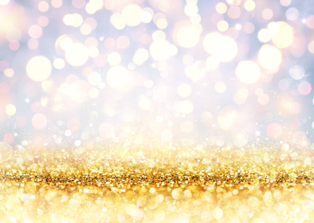 istock Golden Glitter On Shiny backdrop With Blurred Lights 874613628