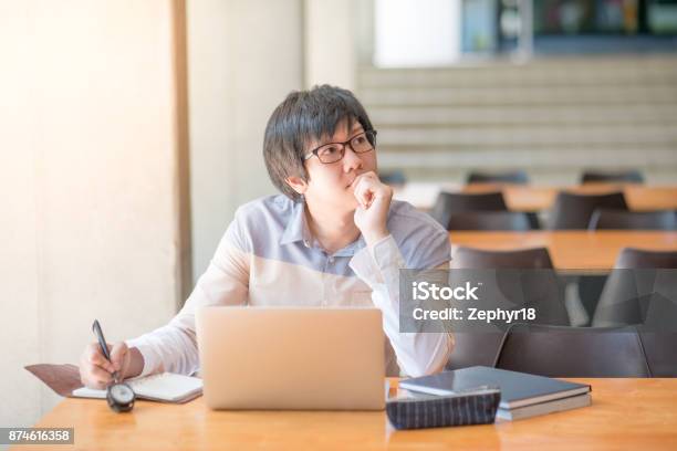 Young Asian Man Working With Laptop And Notebook In University Stock Photo - Download Image Now