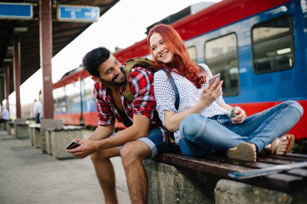 istock Couple waiting at train station 874623316