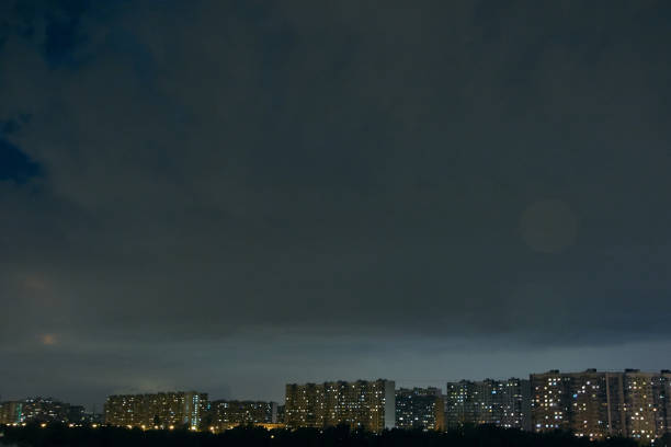 istock Cityscape at dusk with thunderstorm over apartments buildings 874626856