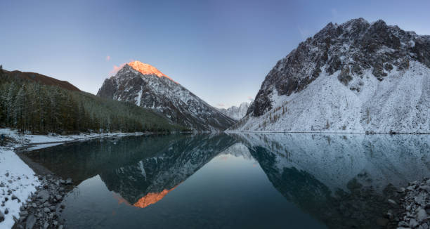 Wide angle view of Montriond Lake on a sunny day, mountains in the background stock photo