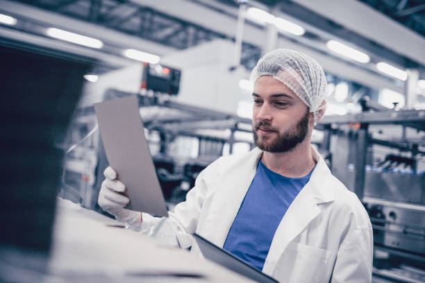 istock Young Scientist Reading Instruction Manual For New Machine 874629630
