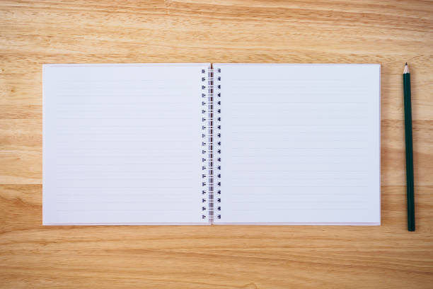 istock notebook top view with pencil on brown wood desk 874632818