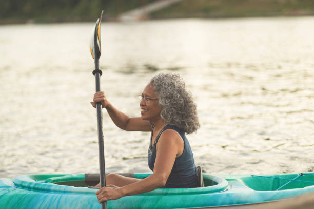 istock Happy senior woman kayaking 874633512