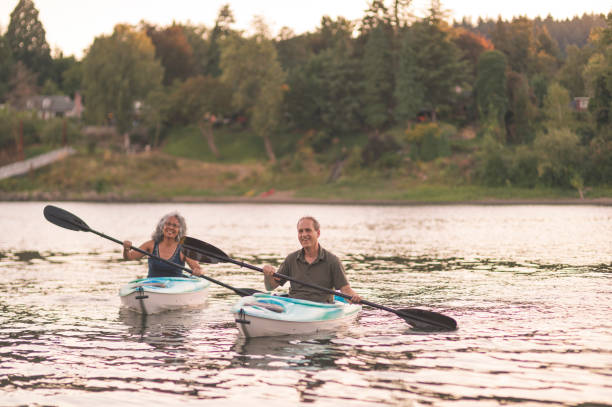 istock Happy senior couple kayaking 874634040