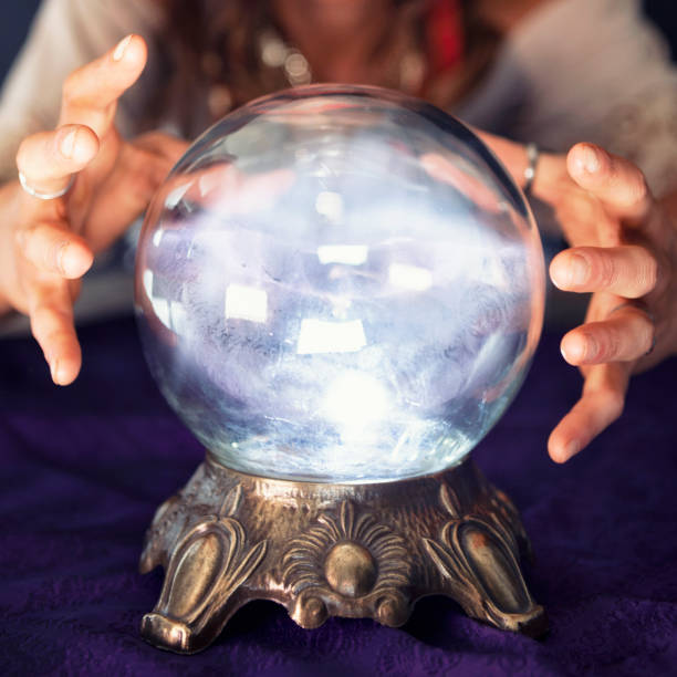 Glowing Crystal Ball Young woman Gypsy using a crystal ball. crystal ball photos stock pictures, royalty-free photos & images