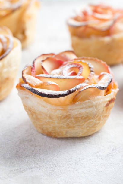 delicious apple roses puff pastry cakes, selective focus
