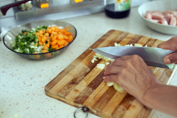 istock Woman chopping vegetables 874641452