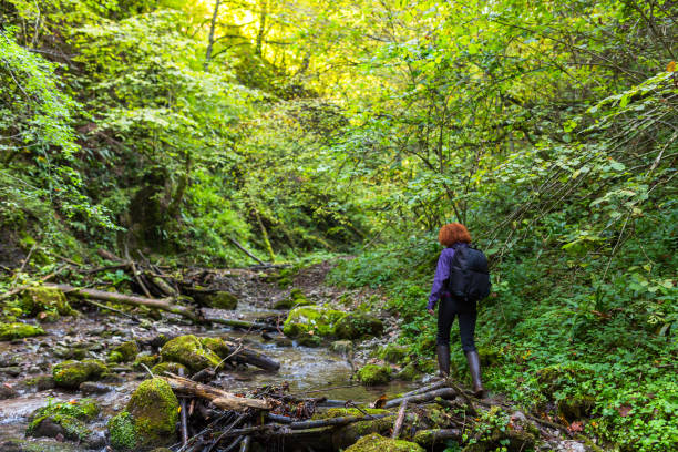istock Hiker woman on a trail by the river 874641610