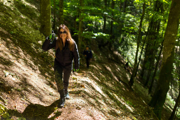 istock Tourists hiking on a trail 874641672