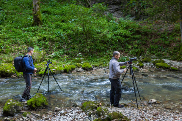 istock Professional photographers with cameras on tripods 874641702