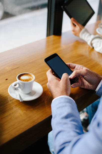 istock Close up of man typing message in cafe bar 874645456