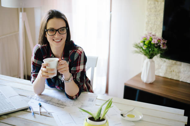 istock Young woman architect having coffee 874652022