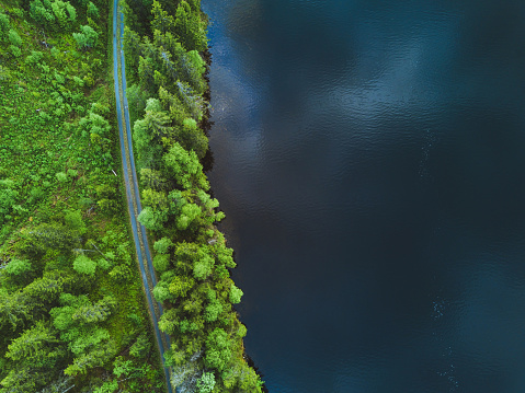 aerial nature background, top view of road and  beautiful texture of water and forest