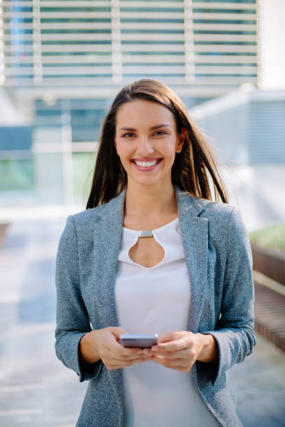 istock Young business woman using mobile phone 874665812