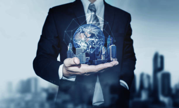 istock Businessman holding buildings with global network connection. Elements of this image are furnished by NASA 874673666