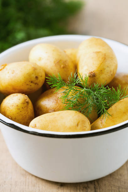 istock raw baby potatoes on wooden surface 874679496