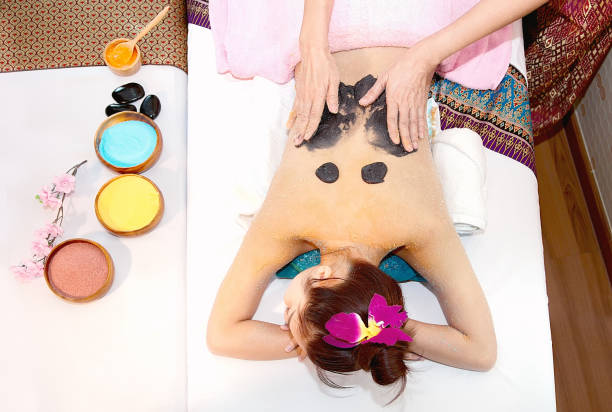 istock Thai pretty woman has scrub her back with charcoal spa salt 874682134