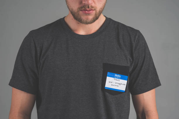istock Man facing audience with name tag that describes struggle 