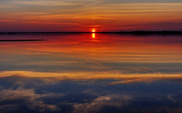 istock Reflection of  the cloudy sky at sunset 874693528